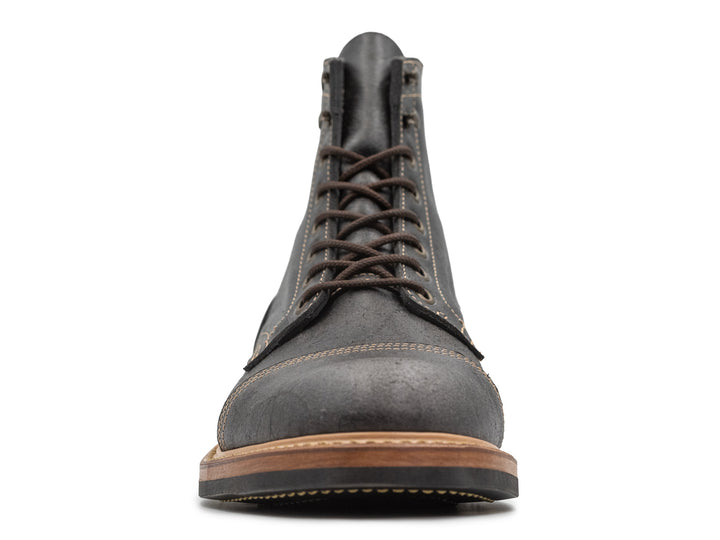 front view of gray textured leather boot on white background