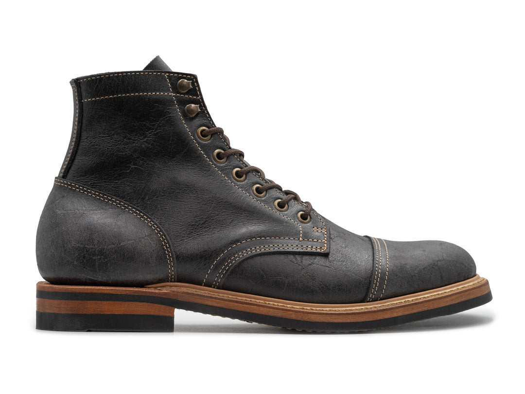 textured gray leather boot on white background