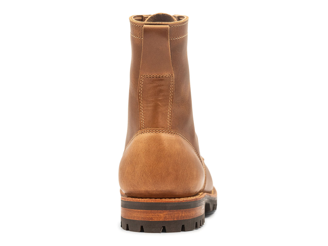 tan leather boot on a white background view from behind