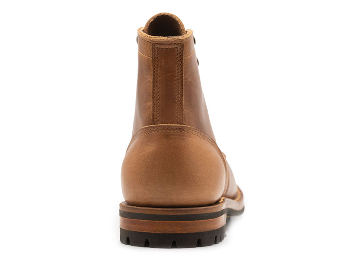 tan leather boot on a white background view from behind