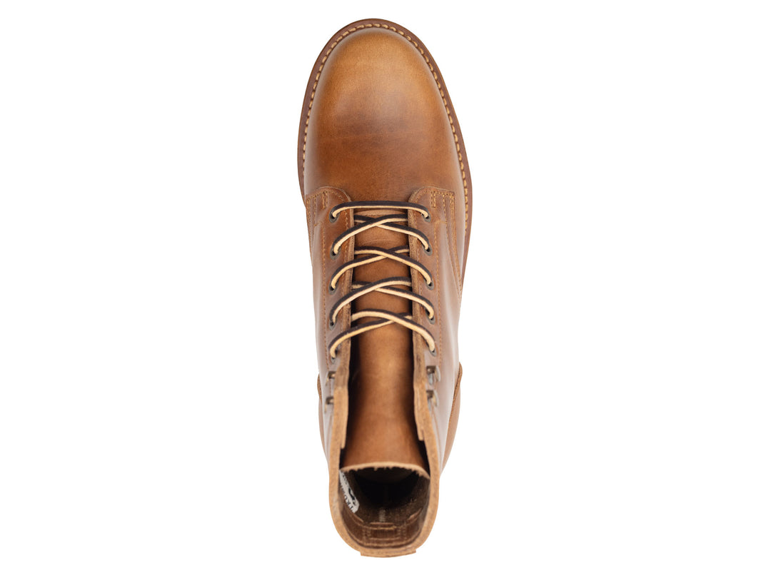 tan leather boot on a white background topdown view