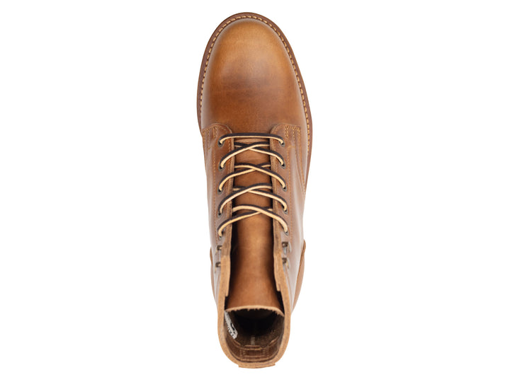tan leather boot on a white background topdown view