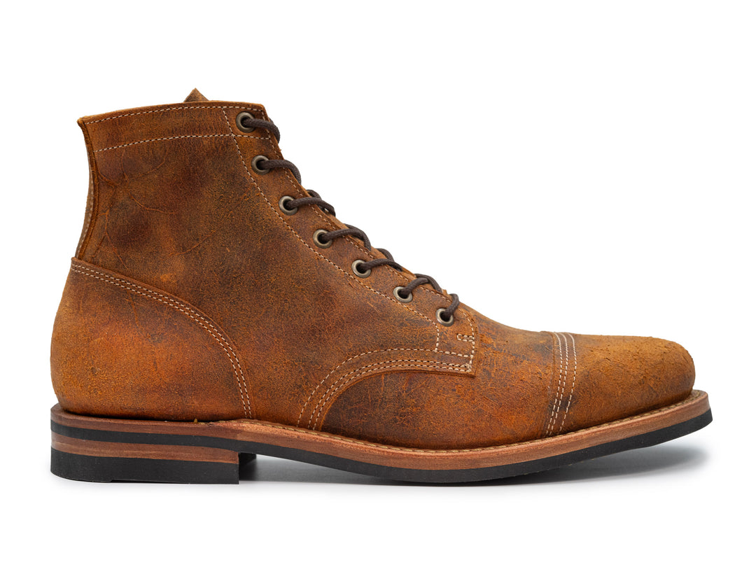 orange textured leather boot on white background