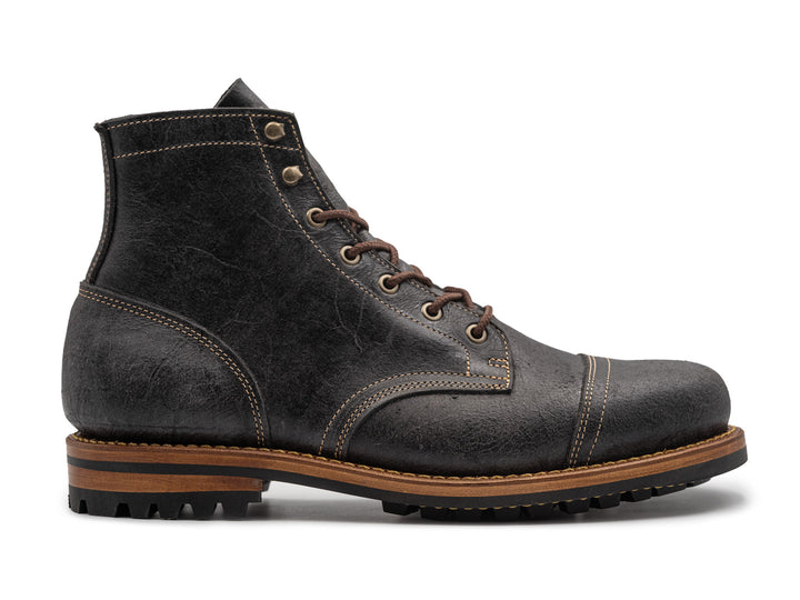 textured gray leather boot on white background