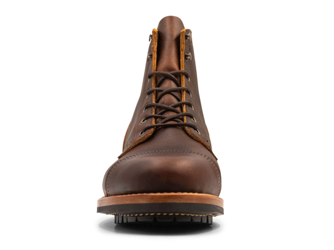 Brown leather boot with a white background front view