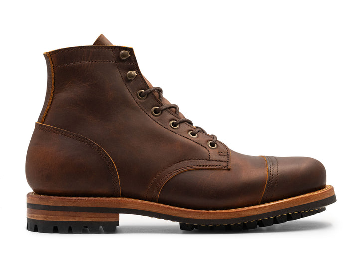 Brown leather boot with a white background side view