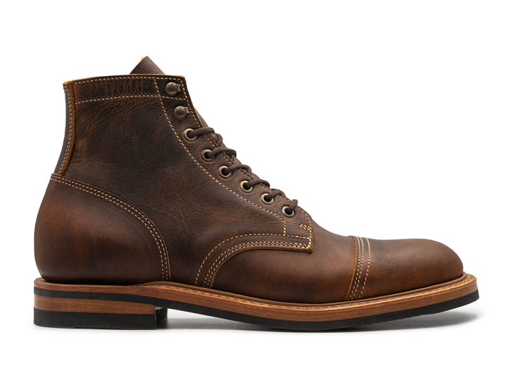 rich brown leather boot on a white background side view