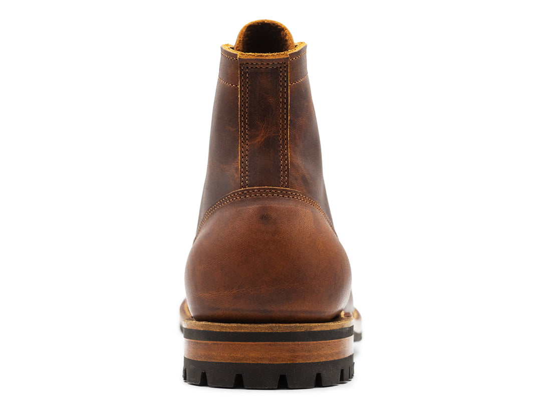 rich brown leather boot on a white background view from behind