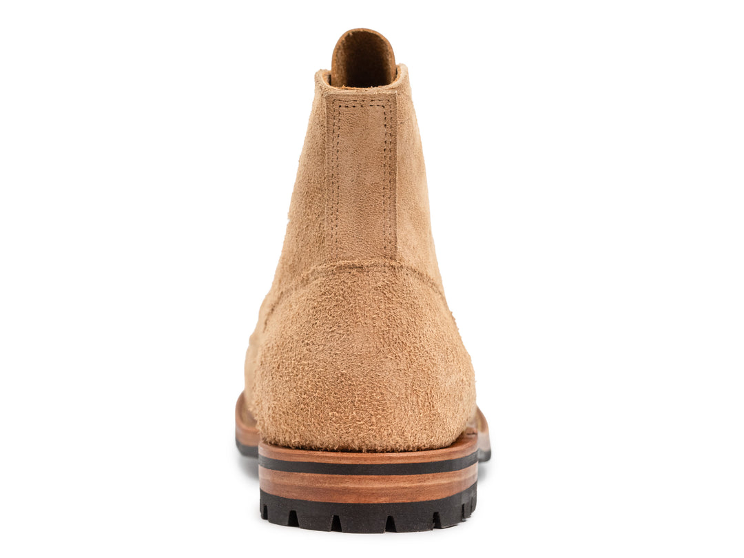 rear view of tan rough out leather boot on white background